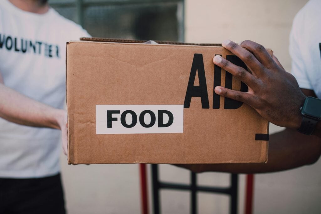 photo of someone holding a box of food for aid